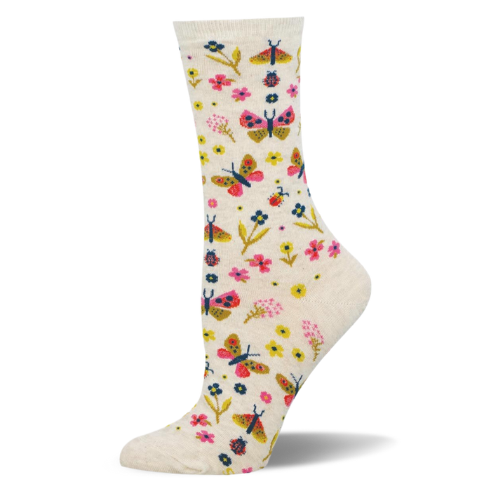 Cream crew socks showing a colorful pattern of pink and yellow butterflies, assorted small flowers, and tiny red ladybugs. }}