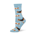 Light blue crew socks featuring a pattern of running basset hounds in classic tricolor and orange and white variations.
