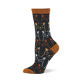 Black bamboo crew sock covered in outlined, sketchy cat faces in white, gold, and orange, with a rust orange toe and heel.