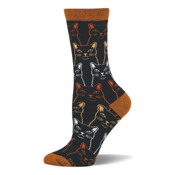 Black bamboo crew sock covered in outlined, sketchy cat faces in white, gold, and orange, with a rust orange toe and heel.