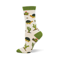 Off-white crew sock with a solid green cuff and matching heel and toe. The pattern features desert tortoises and green cacti.