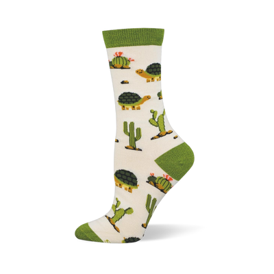 Off-white crew sock with a solid green cuff and matching heel and toe. The pattern features desert tortoises and green cacti.