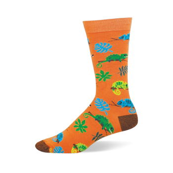 Bright orange crew sock featuring a pattern of blue and green chameleons on branches, tropical leaves, and tiny bugs.