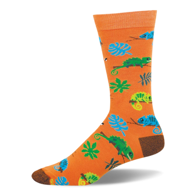 Bright orange crew sock featuring a pattern of blue and green chameleons on branches, tropical leaves, and tiny bugs.