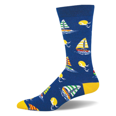 Blue bamboo crew sock featuring colorful striped sailboats, yellow suns, white seagulls, and bright yellow heel and toe.