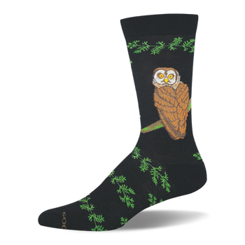 Black bamboo crew sock featuring a large brown owl with yellow eyes perched on a branch, bordered by green leafy patterns.