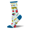 Light blue socks with teal accents, covered in a pattern of school buses, red apples, books, and pencils.
