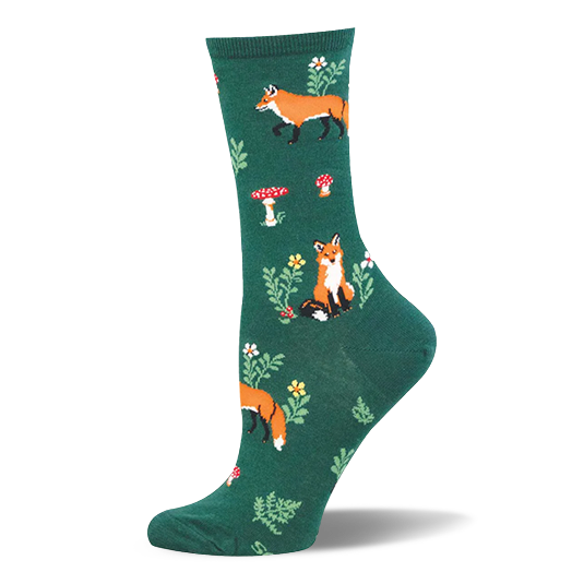 Dark green crew sock with a woodland pattern showing orange foxes, red and white spotted mushrooms, small flowers, and ferns.