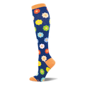 Dark blue knee-high sock with an orange cuff, heel, and toe, covered in a retro pattern of bright, multi-colored daisies.