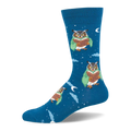 Deep blue crew sock patterned with owls in green cloaks reading books among white stars and pale clouds.