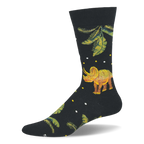 Black crew sock showing a brown and green triceratops standing among giant prehistoric green leaves and tiny white dots.