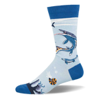 Light blue crew sock with dark blue heel, toe, and cuff. Features swimming Mosasaurus marine reptiles, an ammonite, and bubbles.