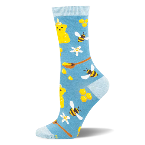Light blue bamboo socks with a pattern of yellow honey bear bottles, flying bees, honeycombs, and wooden spoons.
