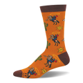 Burnt orange crew socks with dark brown trim featuring a western pattern of cowboys on bucking horses, cacti, and badges.