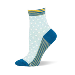 Light blue crew sock showing white pin dots, a teal solid heel and toe, a striped cuff, and a green and blue striped sole.