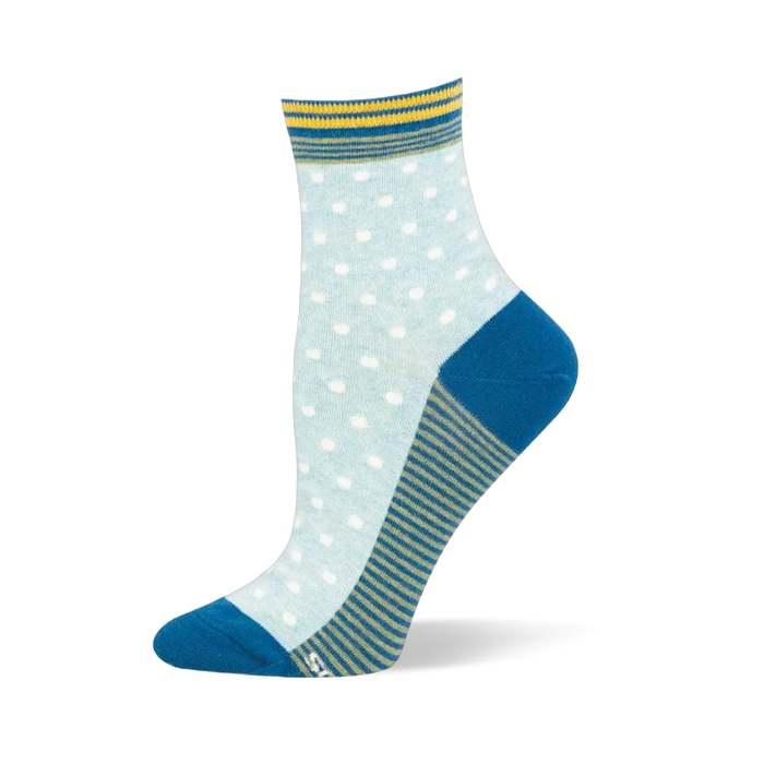 Light blue crew sock showing white pin dots, a teal solid heel and toe, a striped cuff, and a green and blue striped sole.