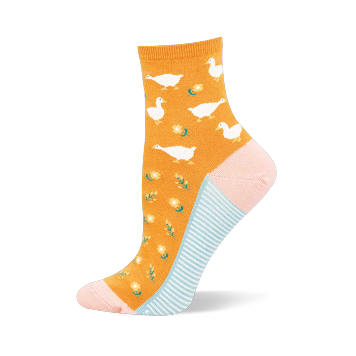 Mustard yellow sock covered in a white goose pattern, featuring a pink heel and toe with light blue stripes on the sole.