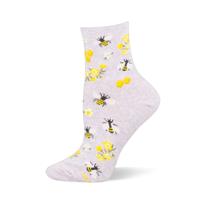 Light grey crew sock with yellow and black bees, golden honeycombs, yellow wildflowers, and white daisies.