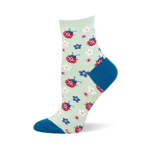 Light mint green crew sock featuring a pattern of red ladybugs and colorful small flowers, with a dark blue toe and heel.