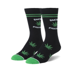 Pair of black crew socks with green marijuana leaf designs and 'Smoke Everyday' text. Green accents on the cuffs.