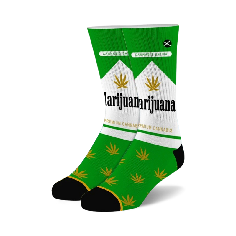 Pair of crew socks with a cannabis-themed design. Green and white color scheme with marijuana leaf imagery and text.