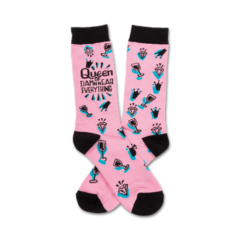 Pink crew socks with black toe and heel. Features a teal and black design of crowns, diamonds, wine glasses, and the text 'Queen of Damn Near Everything'.