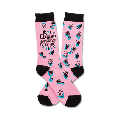 pink crew socks with black text "queen of damn near everything," wine glasses, and diamonds.  