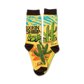 Pair of crew socks, mustard yellow with brown cuffs. Design features cacti, a snake, and the words 'Lookin' Sharp'.