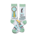 Pair of white crew socks with mint green cuffs. One sock features a 'Got Out of Bed Champion' ribbon; the other shows a figure jumping out of bed next to a clock.