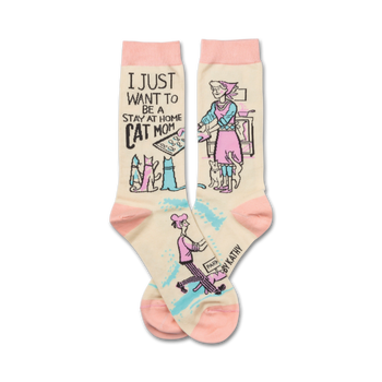 white crew socks with black text "i just want to be a stay at home cat mom" and a drawing of a woman in a pink apron cooking in a kitchen with 4 cats  