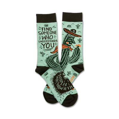 mint green socks with brown toes and heels feature a relaxed cactus in a sombrero smokin' a cigarette surrounded by prickly pears. words state "find someone who understands you."   