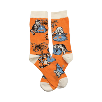 Pair of orange crew socks with a playful illustration of cats looking at fishbowls and a palm tree.  White cuffs.