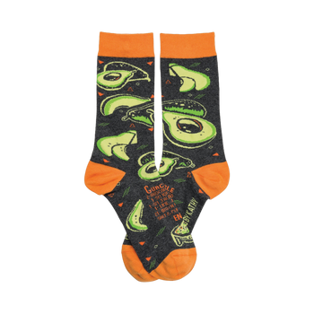 Crew socks in dark gray with orange cuffs.  The pattern shows multiple bright green avocados in various slices, along with a guacamole recipe.