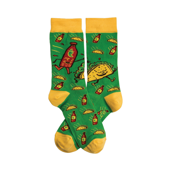 Crew socks in green with yellow cuffs. The design shows cartoon tacos and hot sauce bottles dancing on a green background. }}