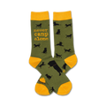 Pair of olive green crew socks with black dog silhouettes and 'Never Camp Alone' text in orange. Yellow cuffs.
