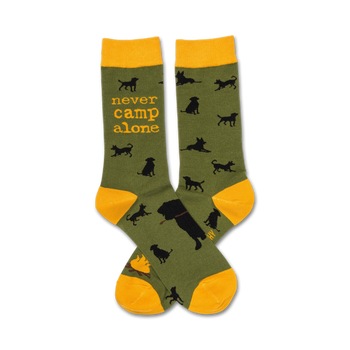 dark green/black dog silhouette crew sock with yellow cuff, which features text " never camp alone".  