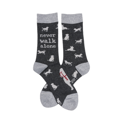 Crew socks, dark gray with light gray cuffs.  Feature white dog silhouettes and the text 'Never Walk Alone'.