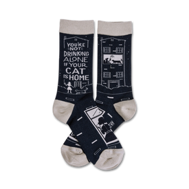 black crew socks with white cat and house design and text "you're not drinking alone if your cat is home."  