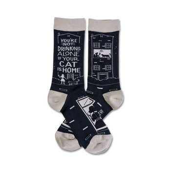 black crew socks with white cat and house design and text "you're not drinking alone if your cat is home."  