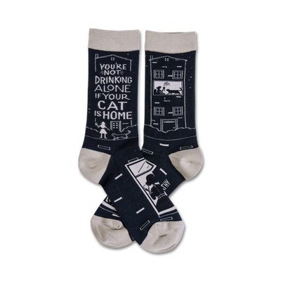 black crew socks with white cat and house design and text "you're not drinking alone if your cat is home."  