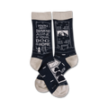 Pair of navy blue crew socks with a beige cuff. The socks feature a witty saying and illustrations of a house and dog.