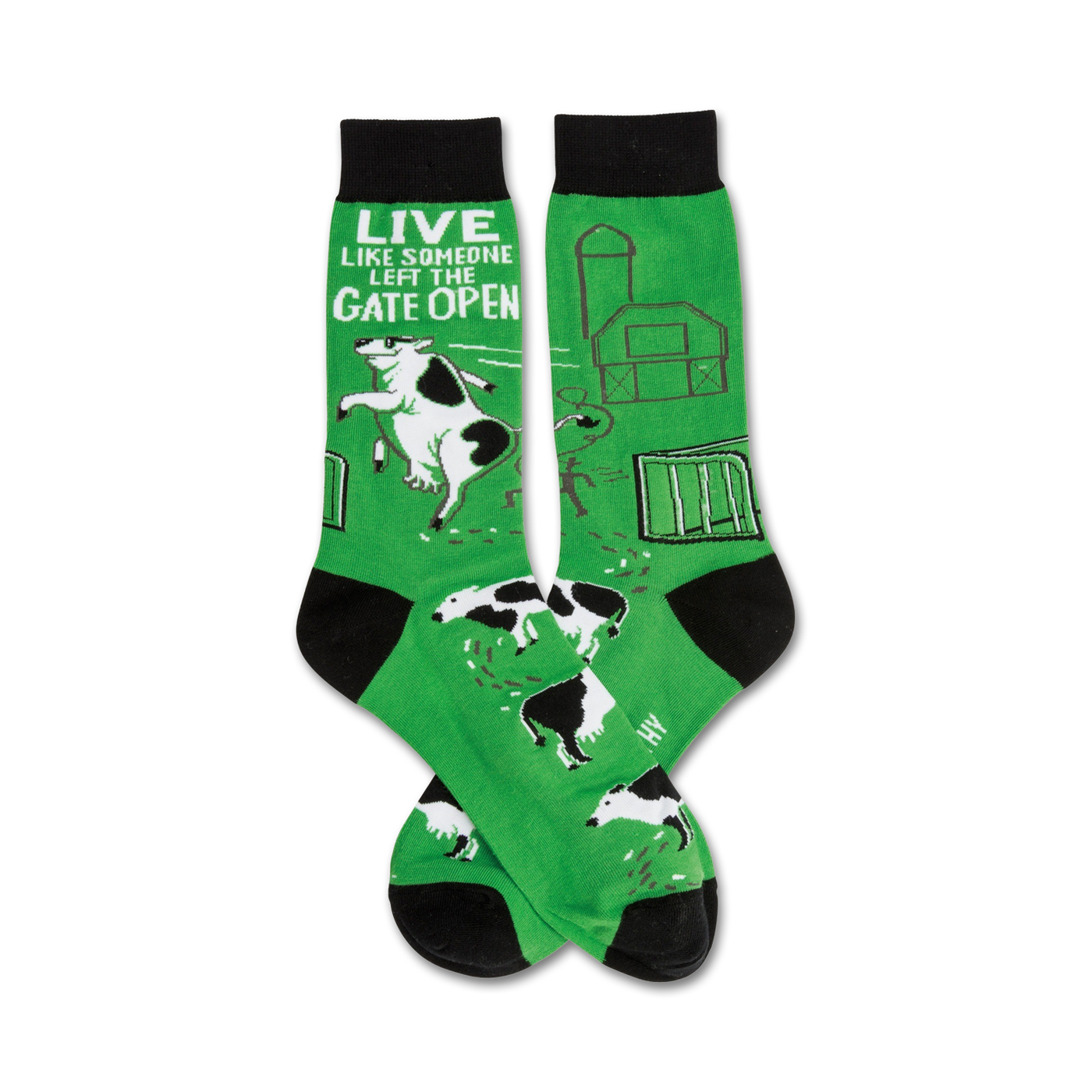 Pair of green crew socks with black toes and cuffs. Design features a farmyard scene with cows escaping, a barn, and the text 'Live like someone left the gate open'.