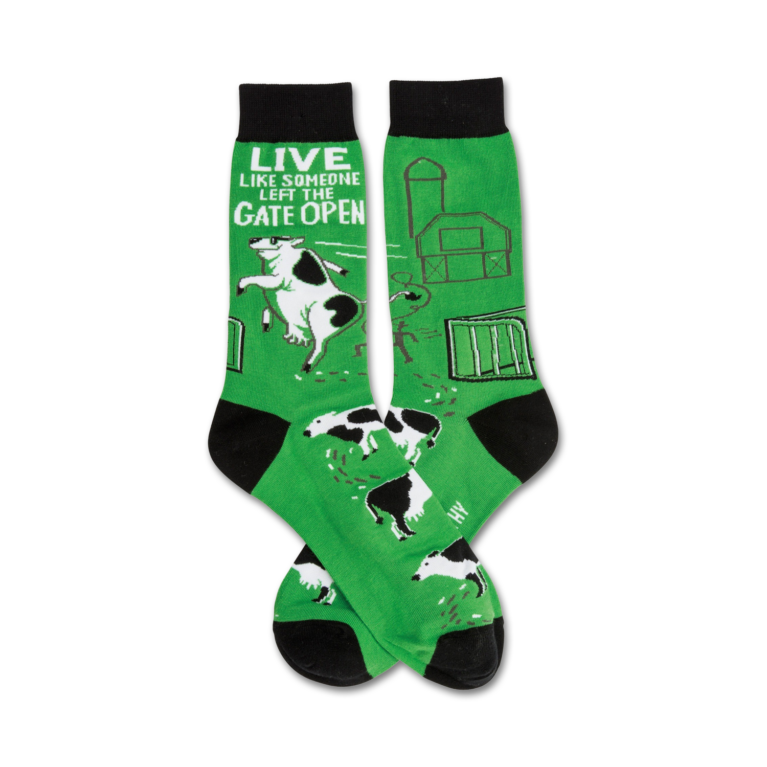 Pair of green crew socks with black toes and cuffs. Design features a farmyard scene with cows escaping, a barn, and the text 'Live like someone left the gate open'.