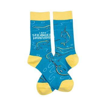 Crew socks in teal blue with yellow cuffs.  Narwhal pattern and the text 'I am strange & wonderful'.
