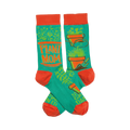 Crew socks in teal and orange.  The design includes potted plants, gardening tools, and the words 'Plant Mom'.