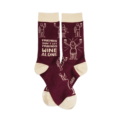 A pair of burgundy crew socks with a beige cuff and toe.  The socks feature a pattern of stick figures drinking wine and the text 'Friends don't let friends wine alone'.