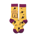 Crew socks in yellow and purple. One sock features a graphic of a light switch with 'Don't make me flip my witch switch' text and flying witch illustrations.