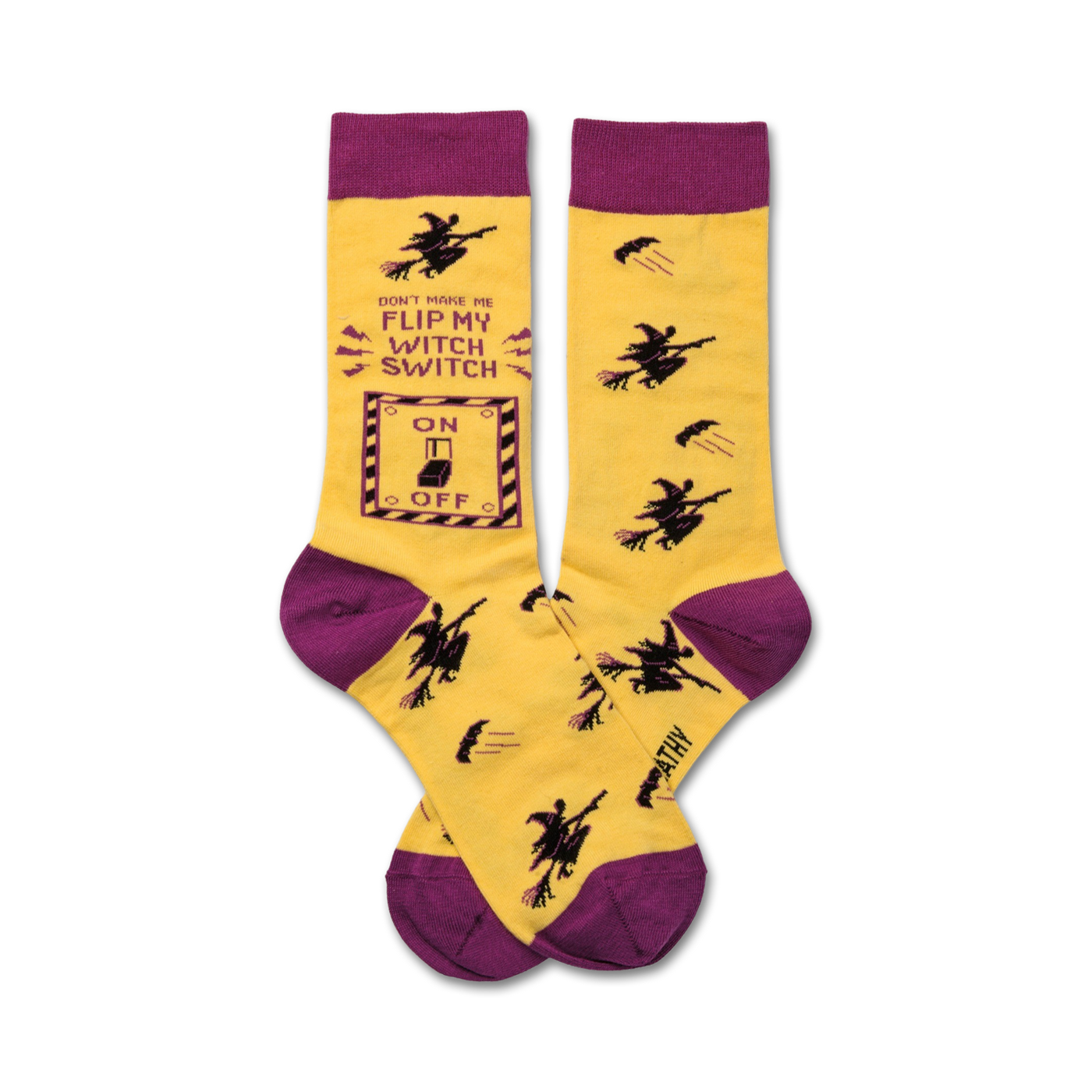 Crew socks in yellow and purple. One sock features a graphic of a light switch with 'Don't make me flip my witch switch' text and flying witch illustrations.