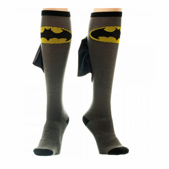 A pair of gray socks with black toes and heels. The socks have a yellow Batman symbol on the front and a black Batman cape that folds down from the top.