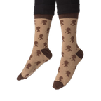 The toe and heel sections of the tan crew socks, highlighted by solid dark brown color blocks.